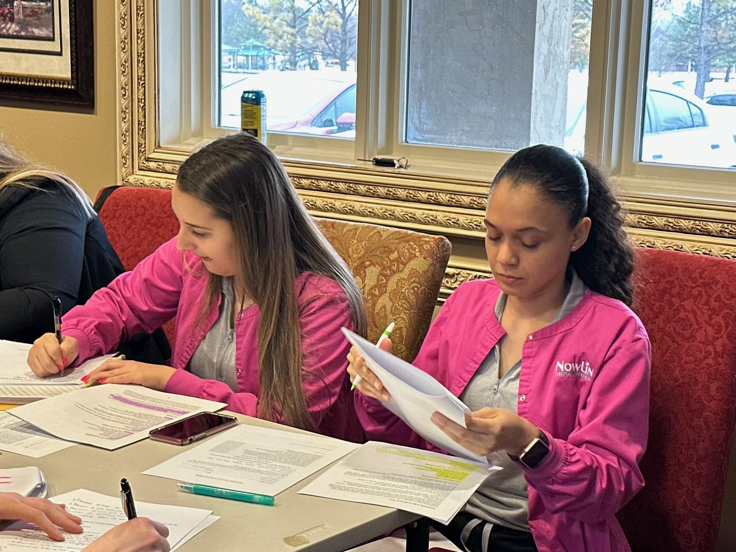 Students holding their certification cards after a class