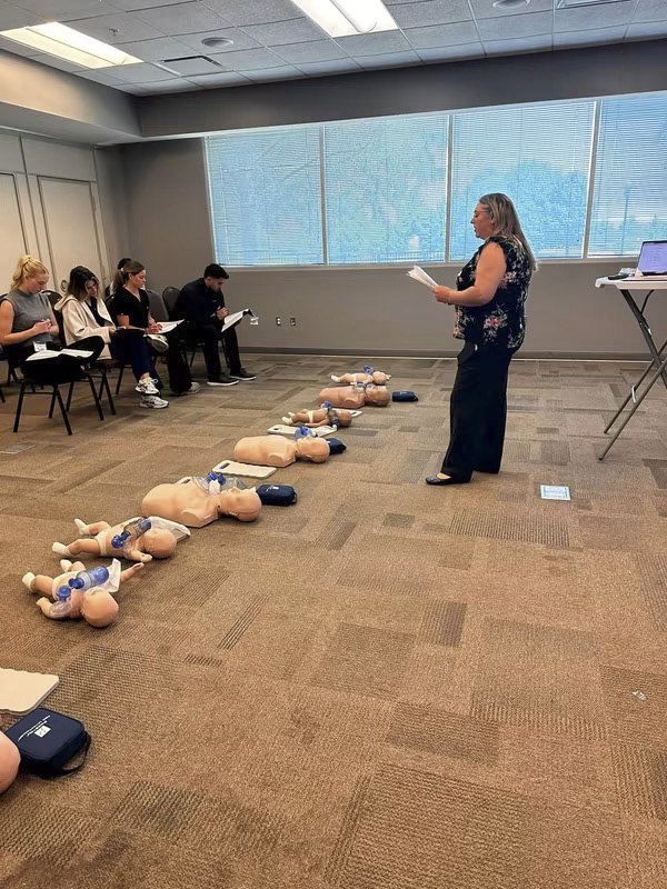 Brook Gibson, RDH, teaching a hands-on CPR class with manikins